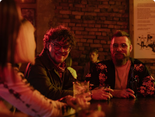 Bartender in the pick-up area retrieves the order on their device, prepares it, and signals the customer once it's ready for pick up.